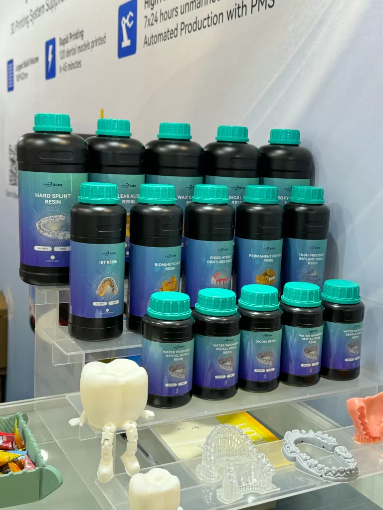 Display of 3D-printed dental resin models and aligner samples by Rayform Technology at Shanghai Dental Exhibition 2025.