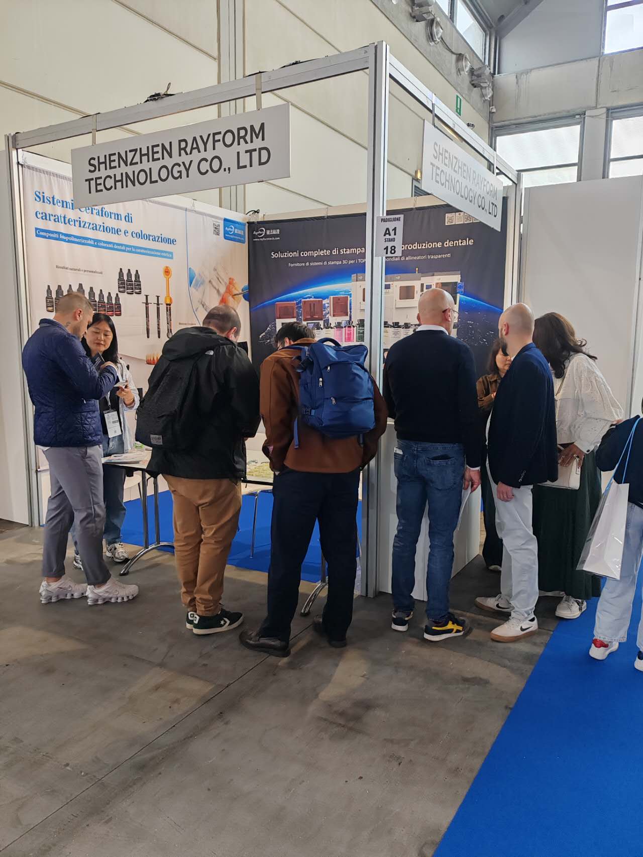 Visitor discussion at RayForm Hall A1 Stand 18 during Expodental Meeting 2026